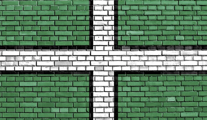 Impression encadrée : Drapeau du Devon peint sur un mur de briques.