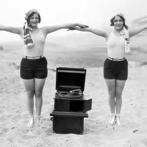 Joan Crawford and Dorothy Sebastian with a Portable Phonograph Print