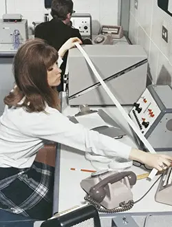 Technician At Work Impressions: A computer technician with data tape
