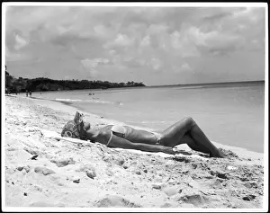 Woman In Bikini Impressions: Sunbathing on Sand