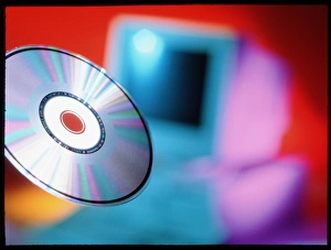 Compact Disc Storage Impressions: View of CD-ROM disc in front of personal computer