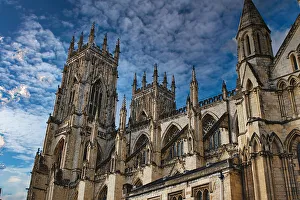 Gothic Cathedral Architecture Impressions: Gothic cathedral tower against a dramatic cloudy sky