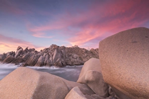 Capo Testa Italy Impressions: Pink sky at sunset frames the lighthouse on cliffs, Capo Testa, Santa Teresa di Gallura