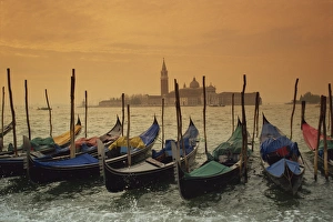 Venice Grand Canal Impressions: View past docked gondolas towards St. Marks Square, from across the Grand Canal