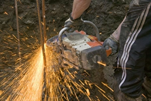 Construction Worker Equipment Impressions: a builder using an angle grinder