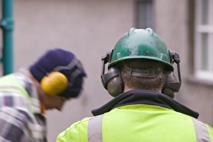 Construction Worker Safety Gear Impressions: Workmen using ear protectors