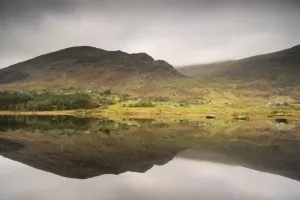 County Kerry Scenery Impressions: Trees and mountains reflected in lake