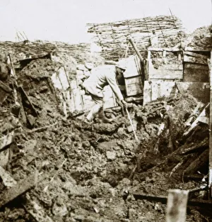 WWI Black And White Pictures Impressions: Aftermath of a shell, a soldier in the crater, c1914-c1918