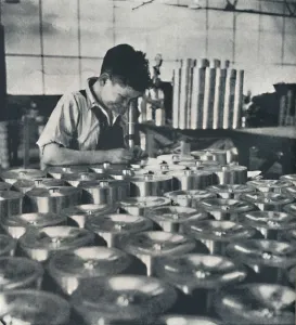Air Transport Industry Impressions: Apprentice with microscope (testing the hardness of pistons), 1941. Artist: Cecil Beaton