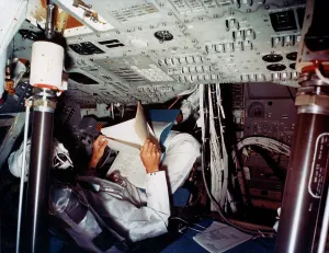 Manned Spaceflight History Impressions: An astronaut inside a NASA Command Module, 1970s. Artist: NASA
