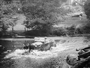 Black And White Car Images Impressions: A Lancia Lambda being driven through water, c1925