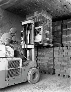 Michael Walters Photography UK Impressions: A yardsman stacking pallets of bricks
