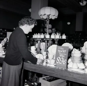 Kensington High Street History Impressions: An elderly lady looking for bargains during january sales at Derry