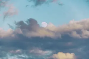 Cloudy Daytime Scene Impressions: Moon surrounded by clouds