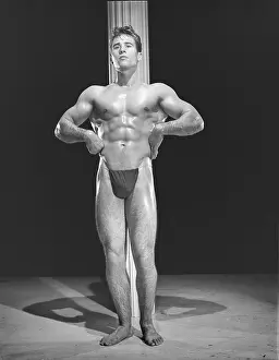 Black And White Muscular Men Impressions: Bodybuilder Poses In Front Of Pole c.1954