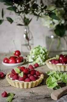 Summer Dessert Ideas Impressions: A cherry and raspberry tart on a kitchen table