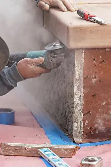 Construction Manpower Impressions: Construction worker using grinder at construction site