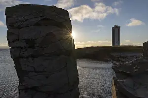 Lighthouse In Iceland Impressions: Basalt column and lighthouse in the backlight
