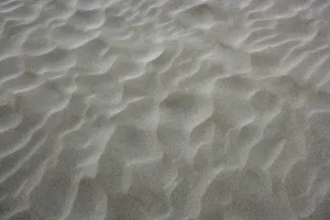 Uninhabited Shoreline View Impressions: Beach sand waves warm texture pattern background