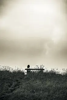 Cloudy Sky Mountain Scenery Impressions: Bench and mountaineer and dramatic clouds in the background