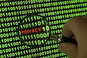 Data Protection Concept Impressions: Binary code with the word 'Privacy' viewed through a magnifying glass Binary code with the word