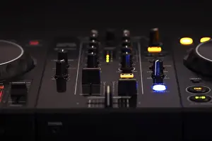 Professional Audio Equipment Impressions: A black DJ mixer with various buttons and knobs