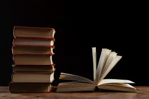 Time Management Calendar Impressions: Books stack with dark background