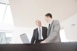Professional Discussion Impressions: Boss and trainee working together on a computer