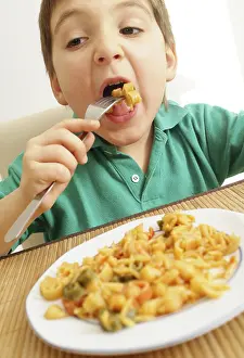 Balanced Diet For Children Impressions: Boy eats pasta dish