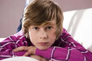 Child Looking Into The Camera Impressions: Boy lying on a couch with a contemplative expression