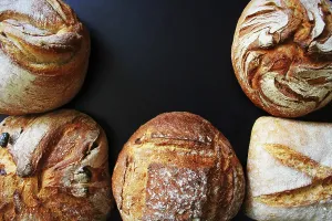 Bakery Products Impressions: Bread. Assortment of different types of bread on a blackn background