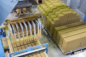 Factory Plant Equipment Impressions: Brickyard. Top view of machine and stacked bricks in workshop