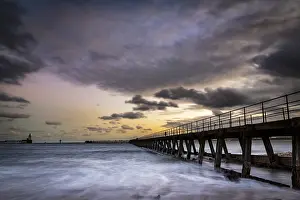 Dramatic Clouds At Sunset Impressions: Bridge in the sea with dramatic clouds at sunset