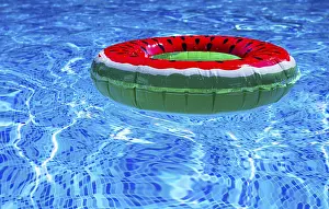 Tropical Water Scene Impressions: A bright ring-a float, with a watermelon