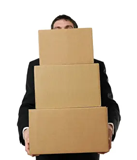 Caucasian Male In Studio Shot Impressions: Businessman overloaded with a stack of boxes