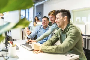 Modern Office Collaboration Impressions: Programmers collaborating on code in a bright