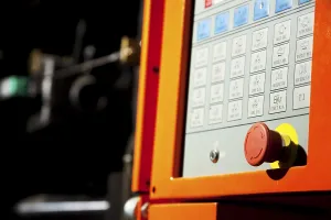 Modern Industrial Architecture Impressions: Complex machine computer control panel with emergency button