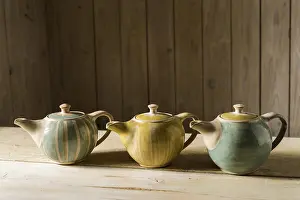Handmade Ceramics Impressions: Ceramic workshop, three glazed pots on workbench