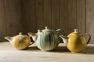 Handmade Ceramics Impressions: Ceramic workshop, three glazed pots on workbench