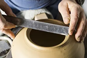 Handmade Pottery Germany Impressions: Ceramic workshop, hands measuring diameter of opening with ruler