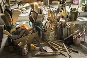 Ceramic Workshop Germany Impressions: Ceramic workshop, tools and brushes in pots on workbench