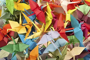 Colorful Bird Photography Impressions: A chaotic array of multicolored origami cranes overlapping each other