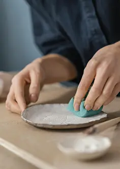 Motion Blur Photography Impressions: Close up hand using blue sponge