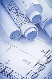 Rolled Up Documents Impressions: Close up view stack of white construction blueprints