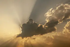 Deserted Landscape France Impressions: Cloud in front of the sun showing rays of light