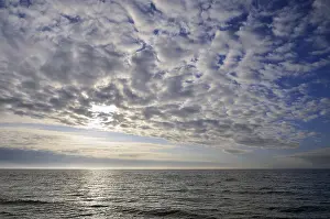 Baltic Sea Evening Atmosphere Impressions: Cloudy sky, cloud formations in front of the setting sun