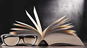 Empty Library Scene Impressions: Composition with open book and glasses on the table