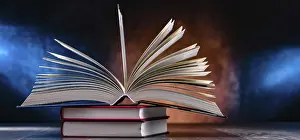 Educational Institution Decor Impressions: A composition with an open book lying on a stack of other books