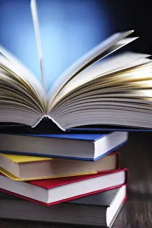 Empty Library Scene Impressions: A composition with an open book lying on a stack of other books