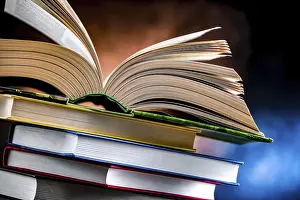 Open Book Impressions: A composition with an open book lying on a stack of other books